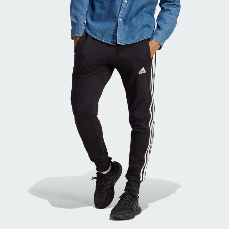 Adidas กางเกงขายาว ESSENTIALS FRENCH TERRY TAPERED CUFF 3-STRIPES | Black / White | (HA4337)